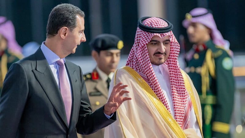Syrian President Bashar Assad, is accompanied by Prince Badr Bin Sultan, deputy governor of Mecca, upon his arrival at Jeddah airport (Saudi Press Agency via AP)