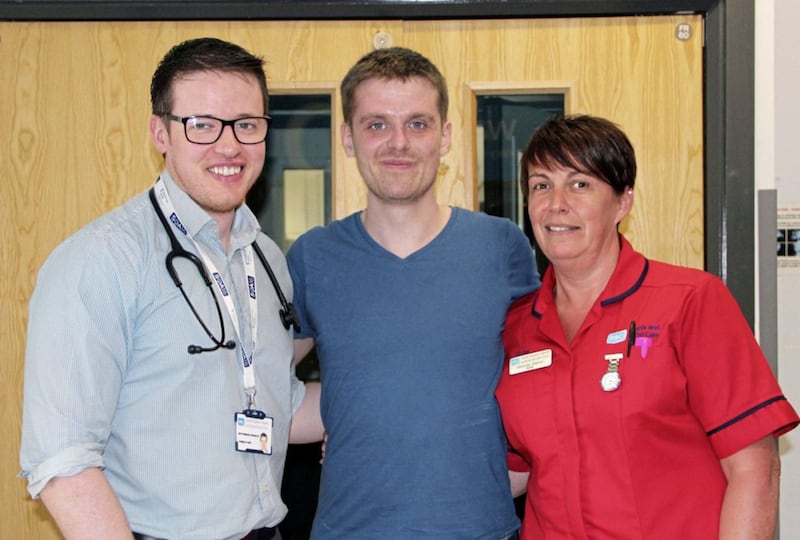 Surfer Matthew Bryce (centre) with consultant Dr Padraig Headley (left) and ward sister Rhonda Marks. Picture from South Eastern Health &amp; Social Care Trust 