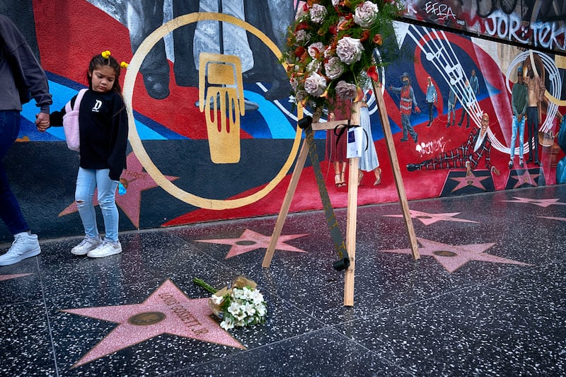 A tourist looks at a memorial wreath that was placed on the Hollywood Walk of Fame star for Louis Gossett Jr
