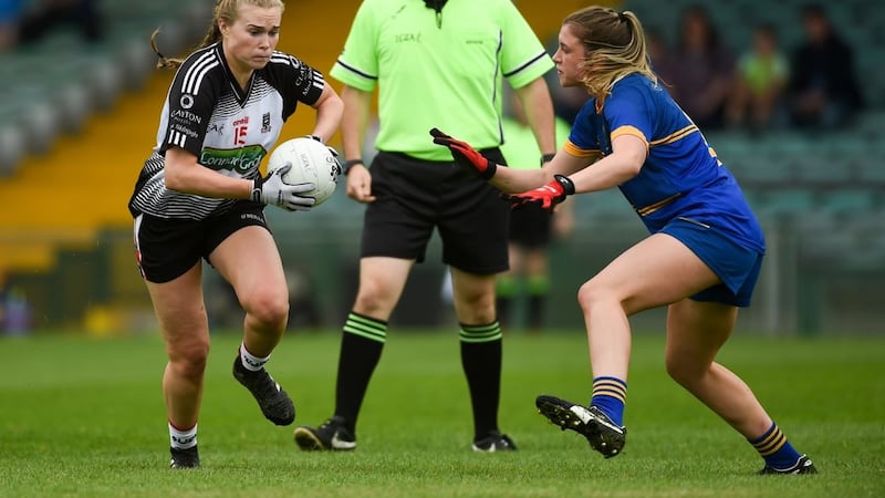 Denise McGrath of Sligo in action against Wicklow&rsquo;s Niamh McGettigan, under the watchful eye of referee Eamonn Moran during the 2018 TG4 All-Ireland Ladies Football Intermediate Championship quarter-final at the Gaelic Grounds in Limerick. Photo: Diarmuid Greene/Sportsfile &nbsp;