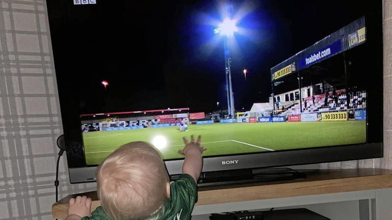 Baby Quinn touches the television screen during her mother&#39;s historic night with Northern Ireland 