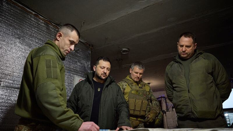 Ukrainian President Volodymyr Zelensky, second left, looks at a map during his visit to the Ukrainian 110th mechanised brigade in Avdiivka, the site of fierce battles with the Russian troops in the Donetsk region
