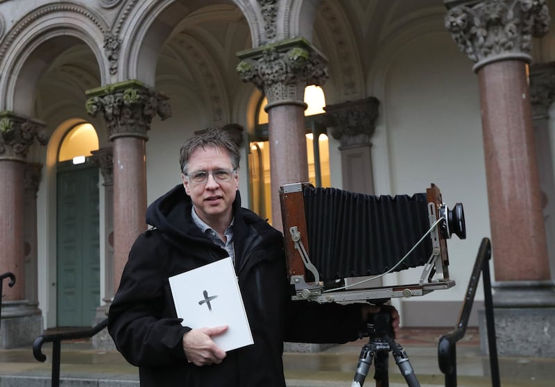 Photographer Greg Miller from America,  who has taken pictures of people on Ash Wednesday for the past 30 years , records parishioners  after a mass at Elmwood Hall at Queen’s University.
PICTURE COLM LENAGHAN