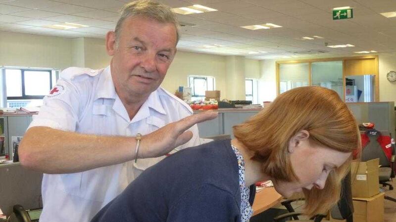 Jock McGowan demonstrates with his Red Cross colleague Judith Kerr what action to take when someone chokes 