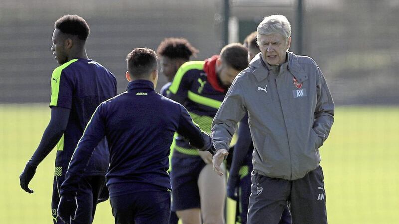 Arsenal&#39;s Alexis Sanchez (left) shakes hands with manager Arsene Wenger (centre) during a training session at the Arsenal Training Centre yesterday Picture by PA 