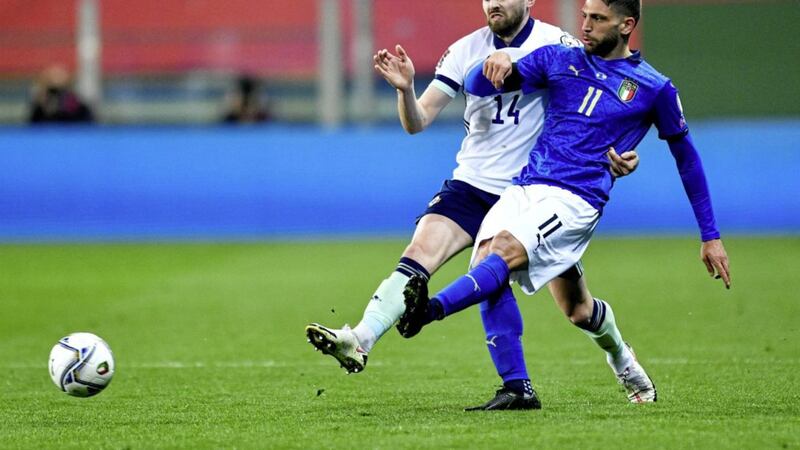 Northern Ireland's Stuart Dallas (left) up against Italy's Domenico Berardi in Parma.