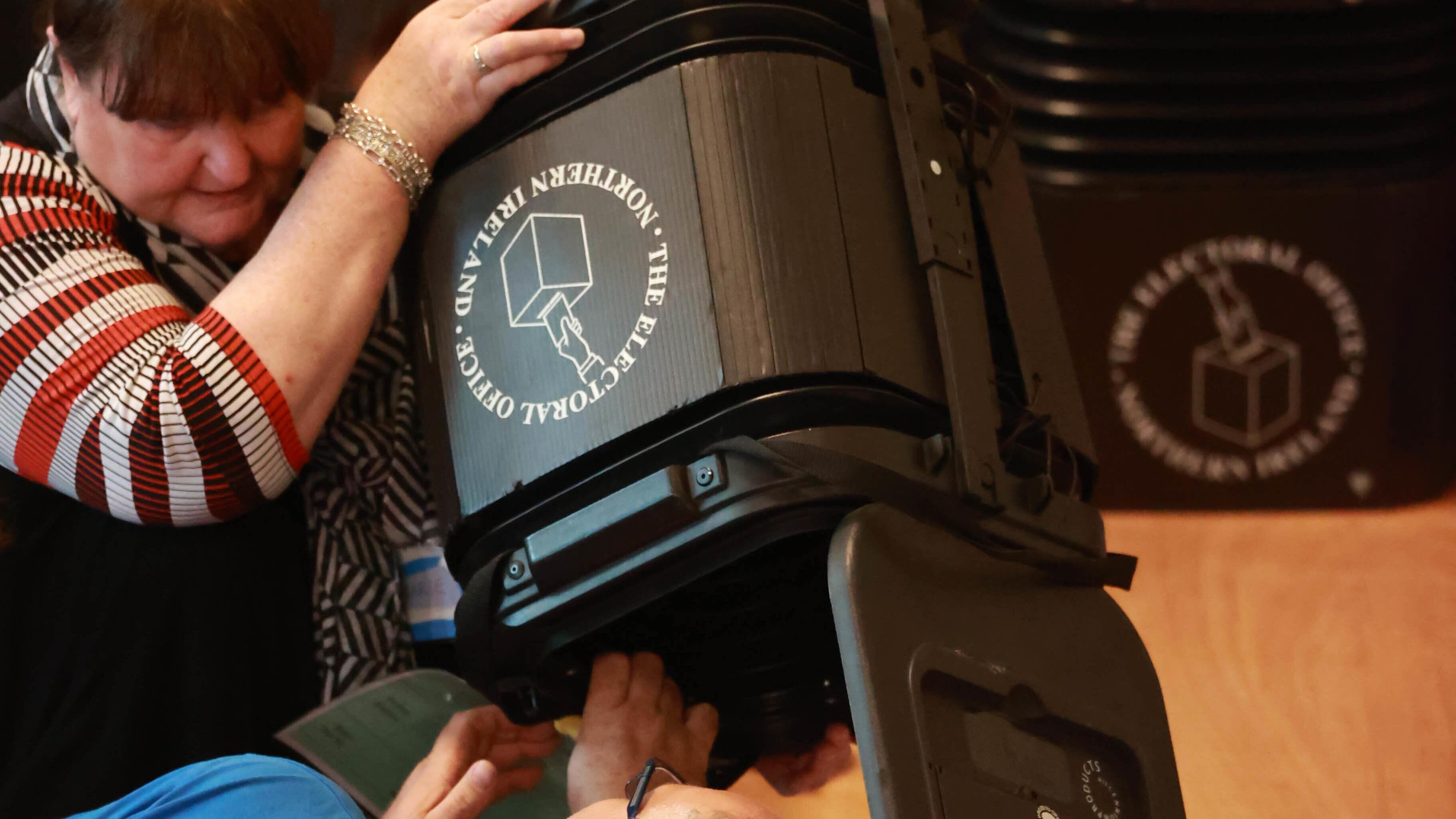Ballot boxes being opened in Belfast City Hall as counting took place in the Northern Ireland council elections. A recount is under way in one seat (Liam McBurney/PA)