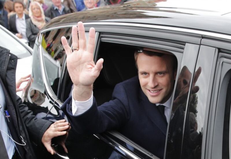 Centrist candidate Emmanuel Macron leaves after casting his vote in the first round of the French presidential election, in le Touquet, northern France