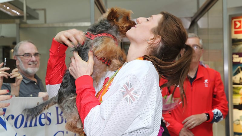 Paralympic Champion Bethany Firth with her dog Russell as she  returns home to Belfast. Picture by Hugh Russell&nbsp;