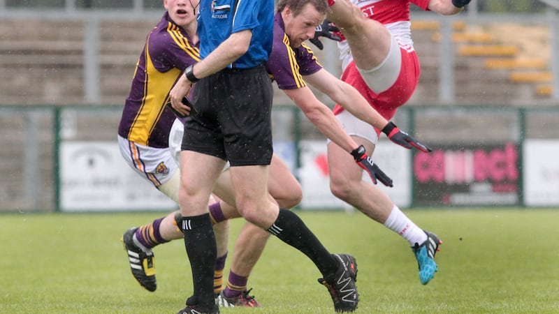 Derry's Eoin Bradley fires over a point as Wexford's Simon Donohoe and Tiernan Rossiter attempt a challenge and referee Fergal Kelly looks on<br /> Picture: Margaret McLaughlin&nbsp;