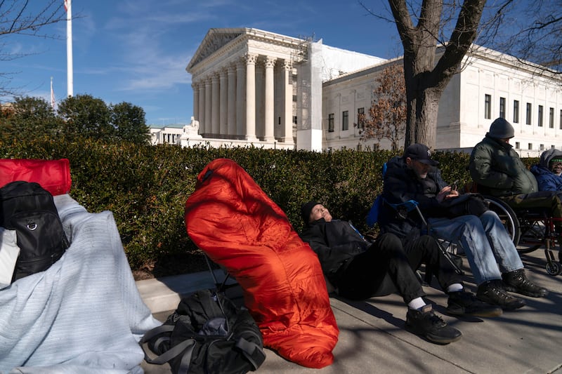 People wait in line outside the US Supreme Court in Washington (Jose Luis Magana/AP)