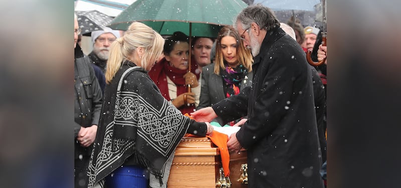 Sinn Fein President Gerry Adams and Michelle O'Neill drape a tricolour over Martin McGuinness' coffin yesterday