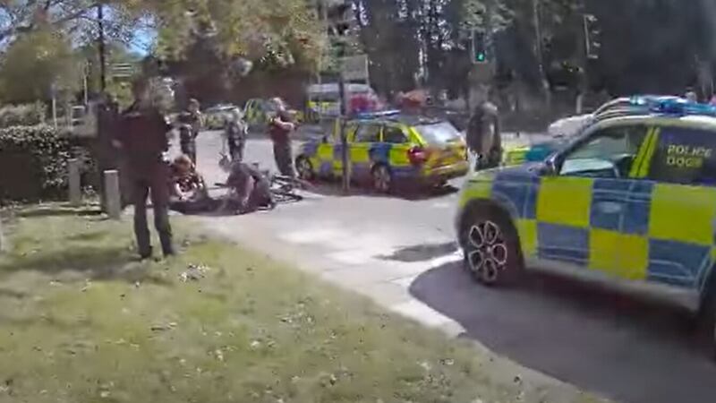 A screenshot of a video showing a Northants Pc using a borrowed bike to arrest a suspect. (Northants Police/PA)