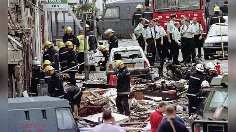 Police and firefighters examine the aftermath of the 1998 Omagh bombing. Picture by Paul McErlane/PA Wire. 