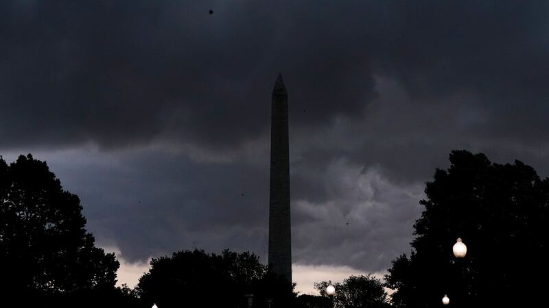 Storm clouds darken the sky over the Washington Monument (Jacquelyn Martin/AP)