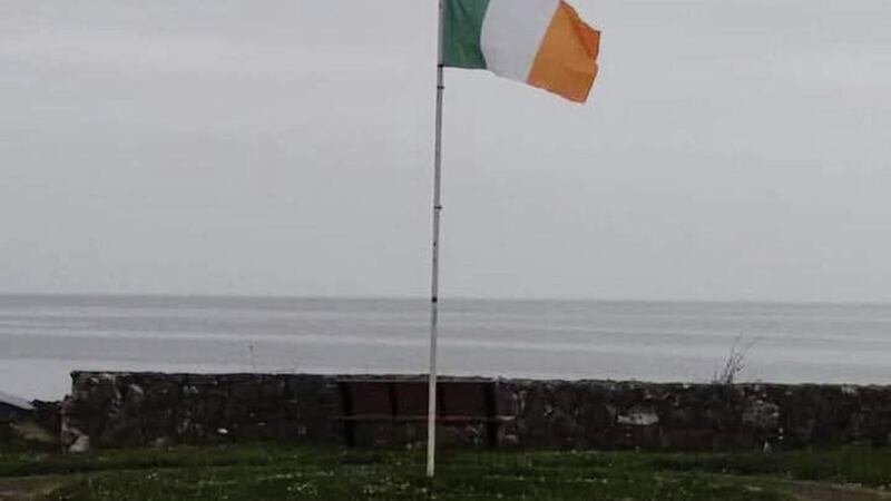 A tricolour and flag removed from council owned property in Carnlough earlier last week 