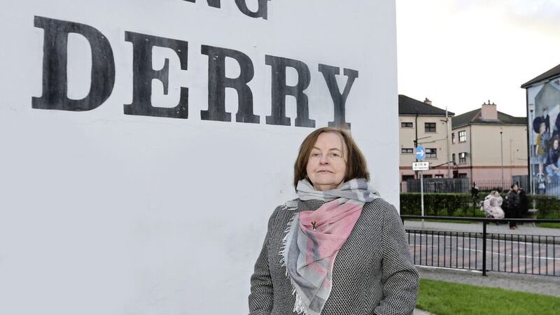 Bernadette McAliskey standing at Free Derry Corner across from a mural where she is depicted in a scene from the &#39;Battle of The Bogside&#39; in the city in August 1969. Picture by Margaret McLaughlin 