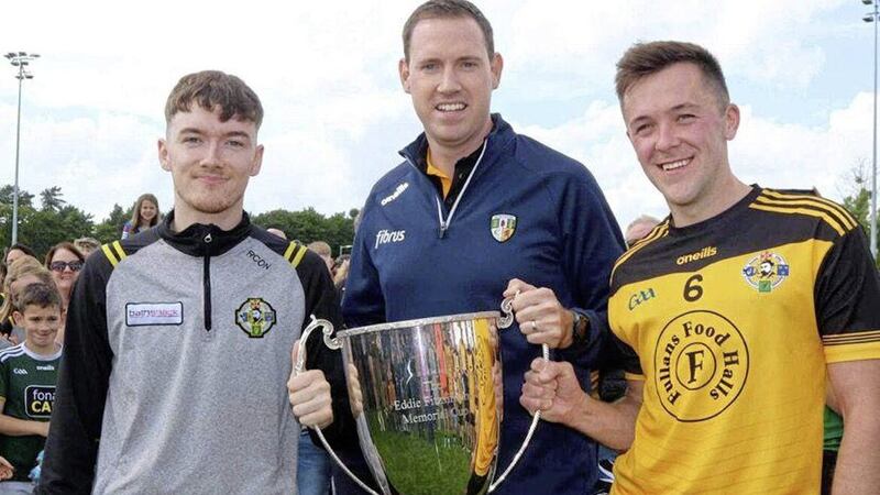 Portglenone joint captains Ryan Convery (left) and Niall Delargy accept the league title from club-mate and county treasurer Donal Murphy, the club&#39;s first in its 82-year history Picture courtesy of Colleen Webb 