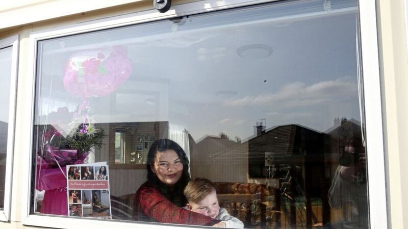 West Belfast toddler D&aacute;ith&iacute; Mac Gabhann and his mother Seph at their caravan in Ballycastle. The family have been forced to return to their home in Belfast. Picture by Mal McCann 
