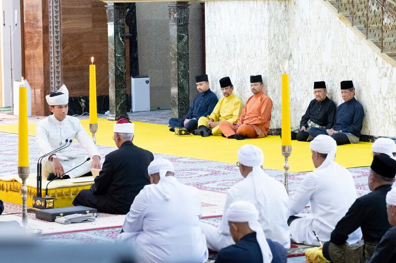 Brunei’s Prince Abdul Mateen, left, sitting during his solemnisation ceremony at Sultan Omar Ali Saifuddien Mosque in Bandar Seri Begawan, Brunei (Brunei’s Information Department via AP)