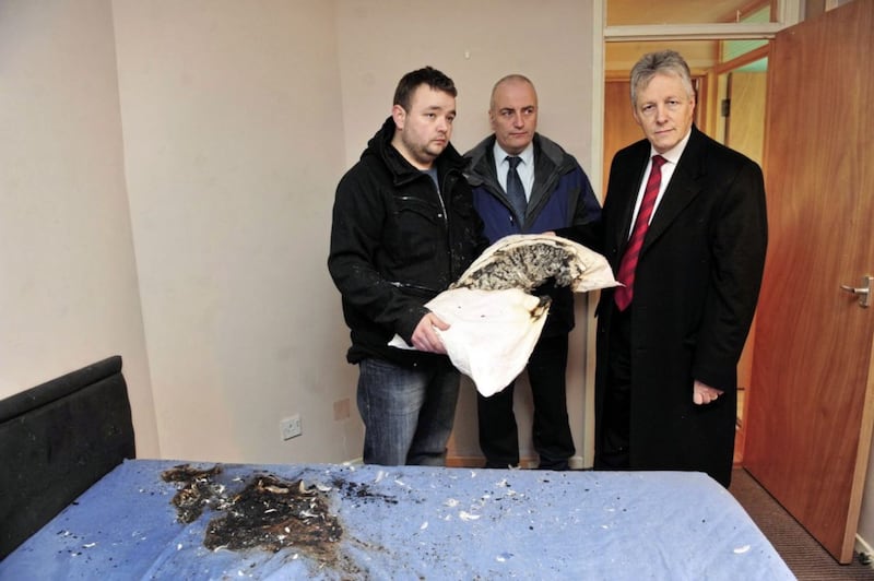 John Smyth jnr in 2011 with DUP MLA Trevor Clarke and then party leader Peter Robinson inspecting pipe bomb damage caused to his home in Antrim 