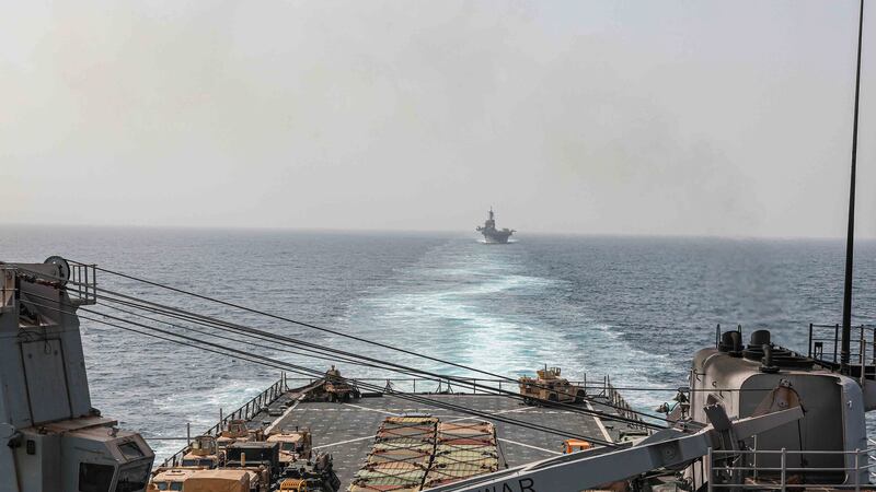 In this image provided by the US Navy, the amphibious dock landing ship USS Carter Hall and amphibious assault ship USS Bataan transit the Bab al-Mandeb strait (Mass Communications Spc. 2nd Class Moises Sandoval/US Navy/AP)