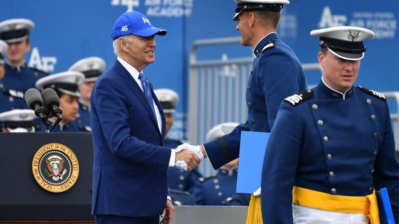 A cadet shakes hands with President Joe Biden after receiving his diploma during the United States Air Force Academy graduation ceremony in Colorado (John Leyba/AP)