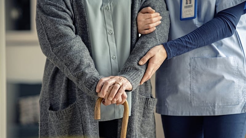 Close up hands of caregiver doctor helping old woman at private clinic. Close up of hands of nurse holding a senior patient with walking stick. Elder woman using walking cane at nursing home with nurse holding hand for support.  