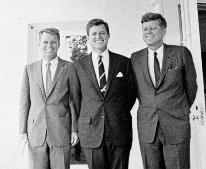 In this 1962 file photo Edward M. Kennedy (centre) poses with his brothers Robert F. Kennedy (left) and President John F. Kennedy at the White House 