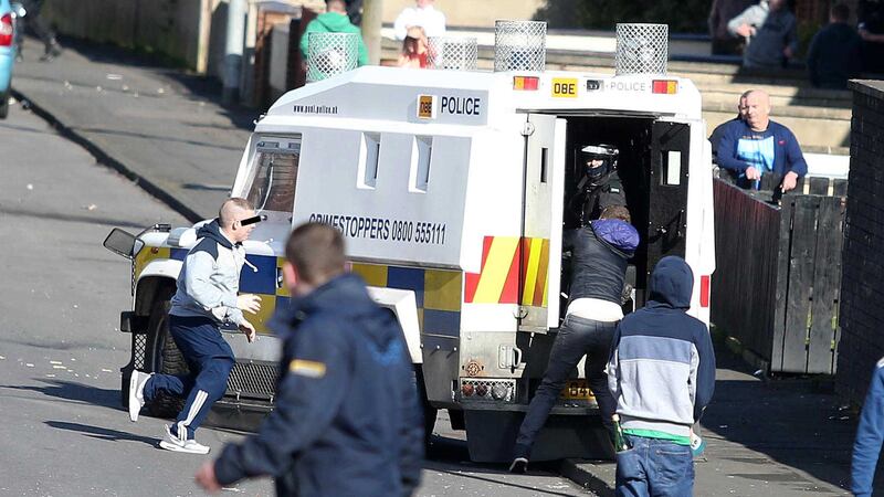 A man reaches into the back of a PSNI Land Rover in an apparent attempt to grab at an officer as nationalists clashed with police in Lurgan's Kilwilkie estate. Picture by Jonathan Porter, PressEye&nbsp;