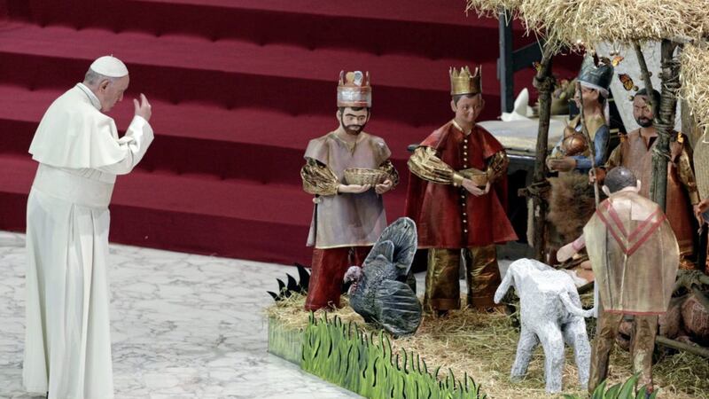 Pope Francis prays in front of a Nativity scene at the Vatican. Picture by AP Photo/Gregorio Borgia