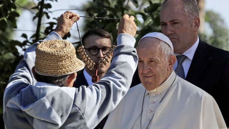 Pope Francis is given a necklace by a member of an Amazonian indigenous community on the feast of St Francis of Assisi, the patron saint of ecology, at the Vatican earlier this month. Picture by Alessandra Tarantino 