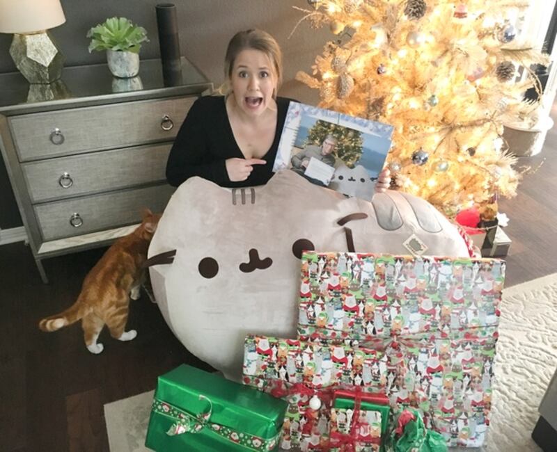 Megan poses for a photo with the gifts Bill Gates sent