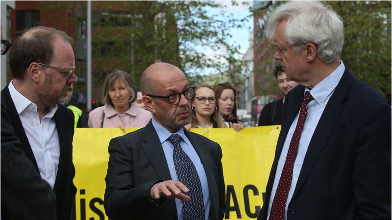 Conservative MP David Davis (right) speaks to Trevor Birney (left) and Barry McCaffrey outside the High Court in Belfast this morning. Picture by Hugh Russell