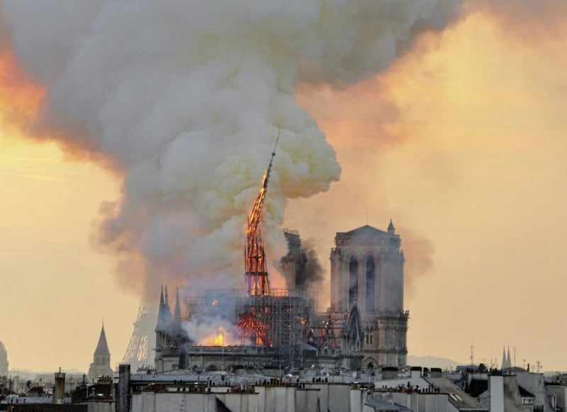 Flames and smoke rise from the blaze as the spire starts to topple on Notre Dame cathedral in Paris. Picture by AP Photo/Thierry Mallet 