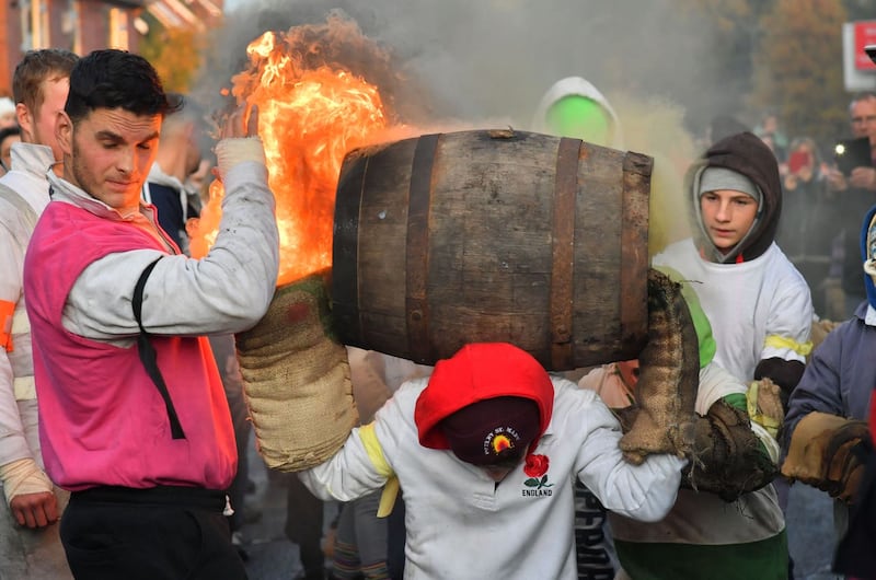 Children carrying burning barrels