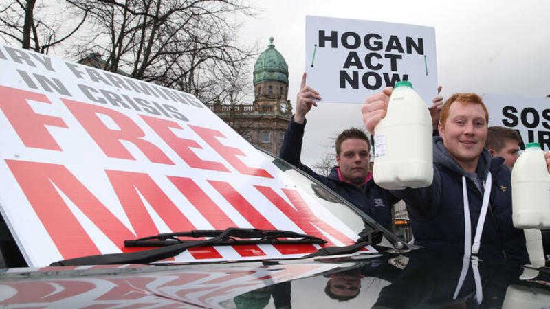 Farmers handing out free milk during a protest outside Belfast City Hall yesterday. Picture by Hugh Russell 