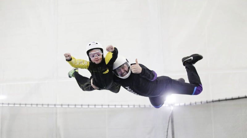 Jenny Lee&#39;s seven-year-old son Noah gets a thumbs up from instructor Artis at Vertigo Indoor Skydiving 
