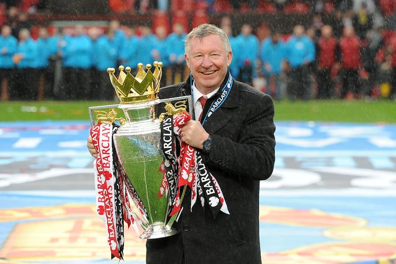 Sir Alex Ferguson celebrates with the 2012-13 Premier League trophy