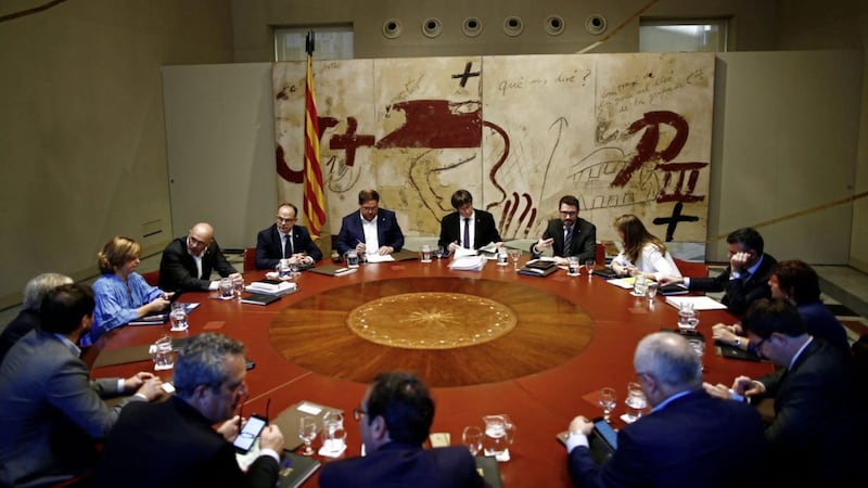 Catalan president Carles Puigdemont, centre, attends a meeting at the Palau Generalitat in Barcelona earlier this week 