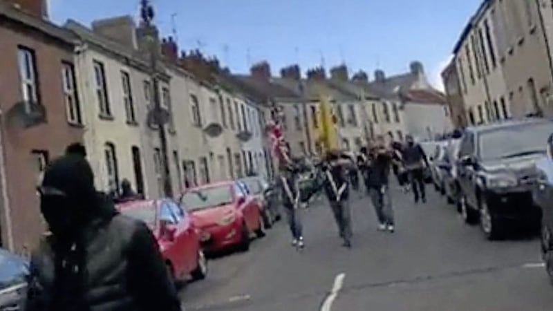 Masked men taking part in an illegal parade in Portadown, Co Armagh, on Monday. Picture from Pacemaker 