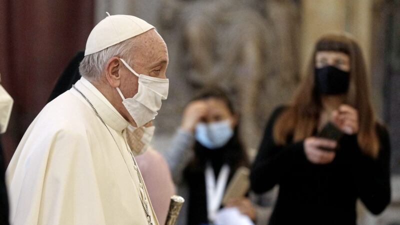 Pope Francis, pictured wearing a face mask as he arrived to attend an inter-religious ceremony for peace in Rome last week, has caused controversy with his comments about same-sex civil unions. Picture by AP Photo/Gregorio Borgia 