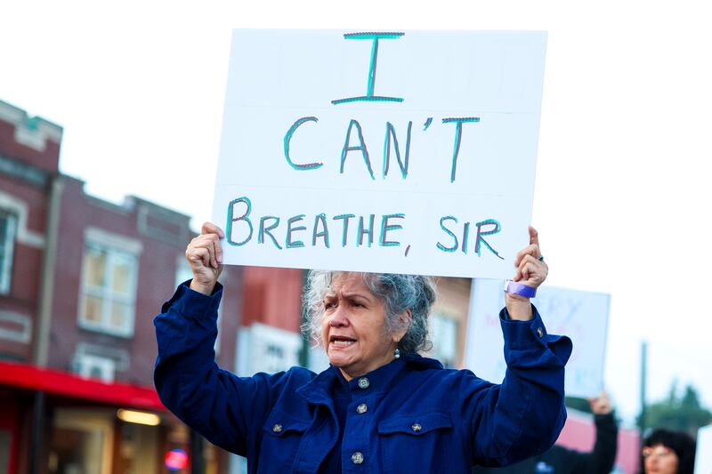 A protester holds a sign during a rally after the verdict was read during the trial (AP Photo/Maddy Grassy)