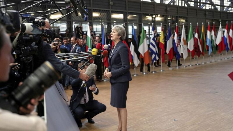 British Prime Minister Theresa May speaks with the media as she arrives for an EU summit in Brussels yesterday.&nbsp;<br />Picture by Francisco Seco/AP