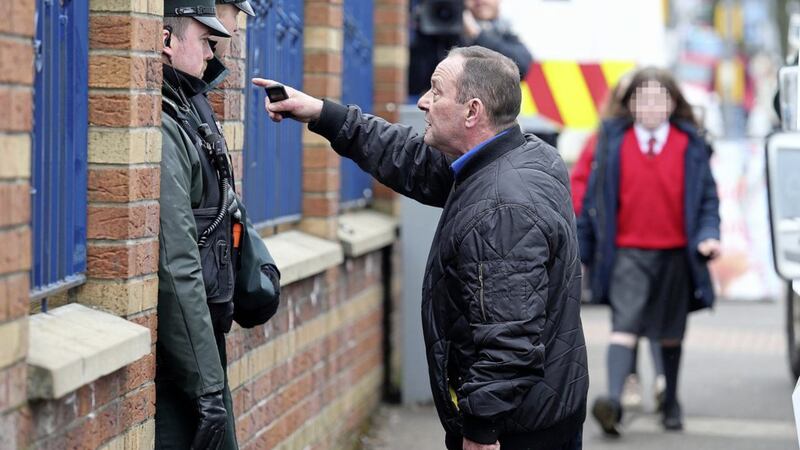 IRSP member Gerard Foster remonstrates with police outside the offices of the IRSP in west Belfast Picture Mal McCann. 