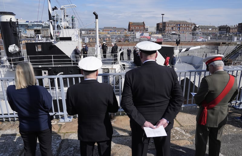 Members of the Royal Navy, Royal New Zealand Navy and Royal Australian Navy take part in an Anzac Day service of remembrance on board HMS M.33 at Portsmouth Historic Dockyard