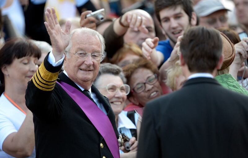 Belgium’s King Albert II waves to the crowd as he leaves a service at St Gudule Cathedral in Brussels in July 2013 (Ezequiel Scagnetti/AP)
