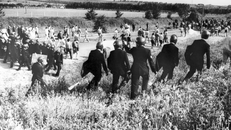 Police in anti-riot gear escorting picketers away from their position near the Orgreave Coking Plant near Rotherham (PA)