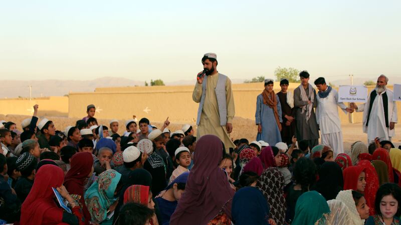 Matiullah Wesa, pictured reading to students in the Spin Boldak district in the southern Kandahar province of Afghanistan, has been freed from prison (Siddiqullah Khan/AP)