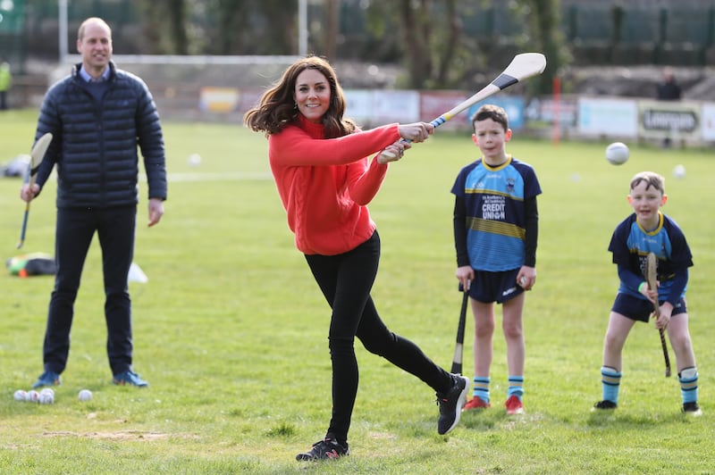 Kate trying out hurling during a visit to a local Gaelic Athletic Association (GAA) club in Ireland
